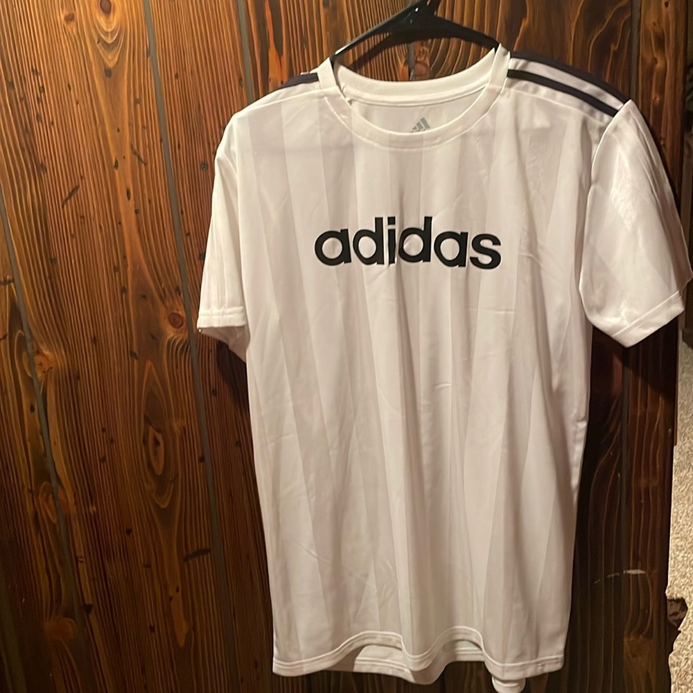Adidas kids size xl white with black strip on shoulders jersey new with out tags